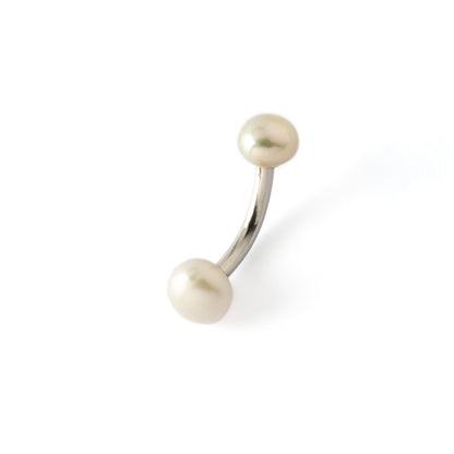 curved surgical steel navel bar with two white pearls, one at the top and a bigger one at the bottom side view
