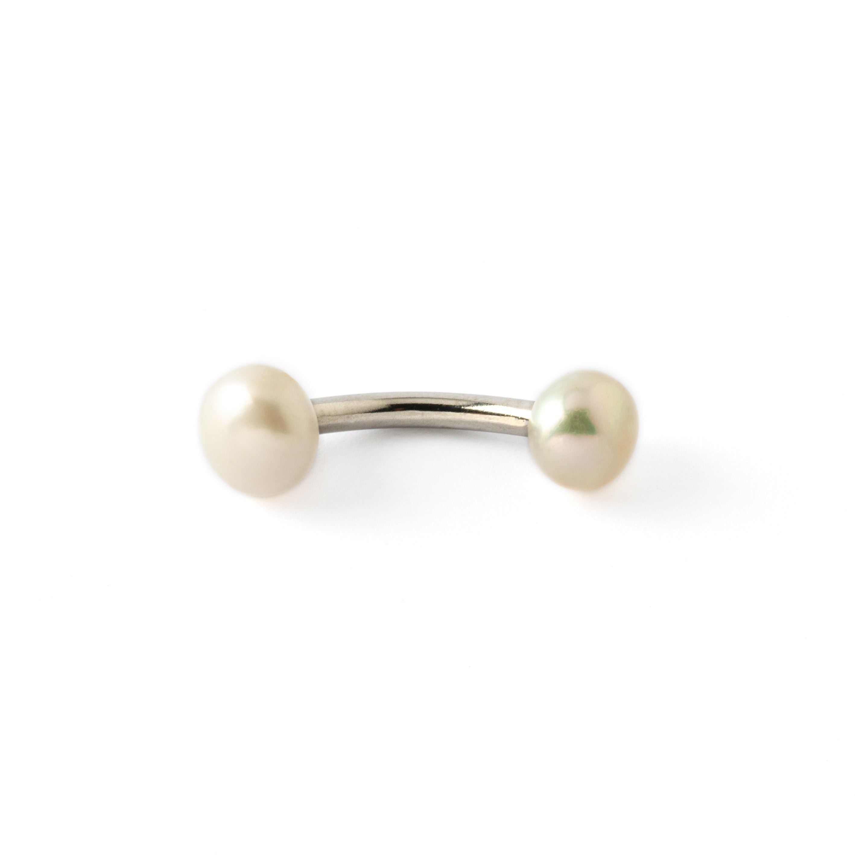 curved surgical steel navel bar with two white pearls, one at the top and a bigger one at the bottom down view